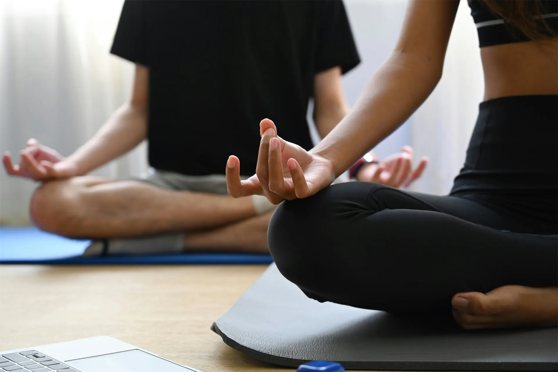 Students practicing together in a sunlit yoga studio