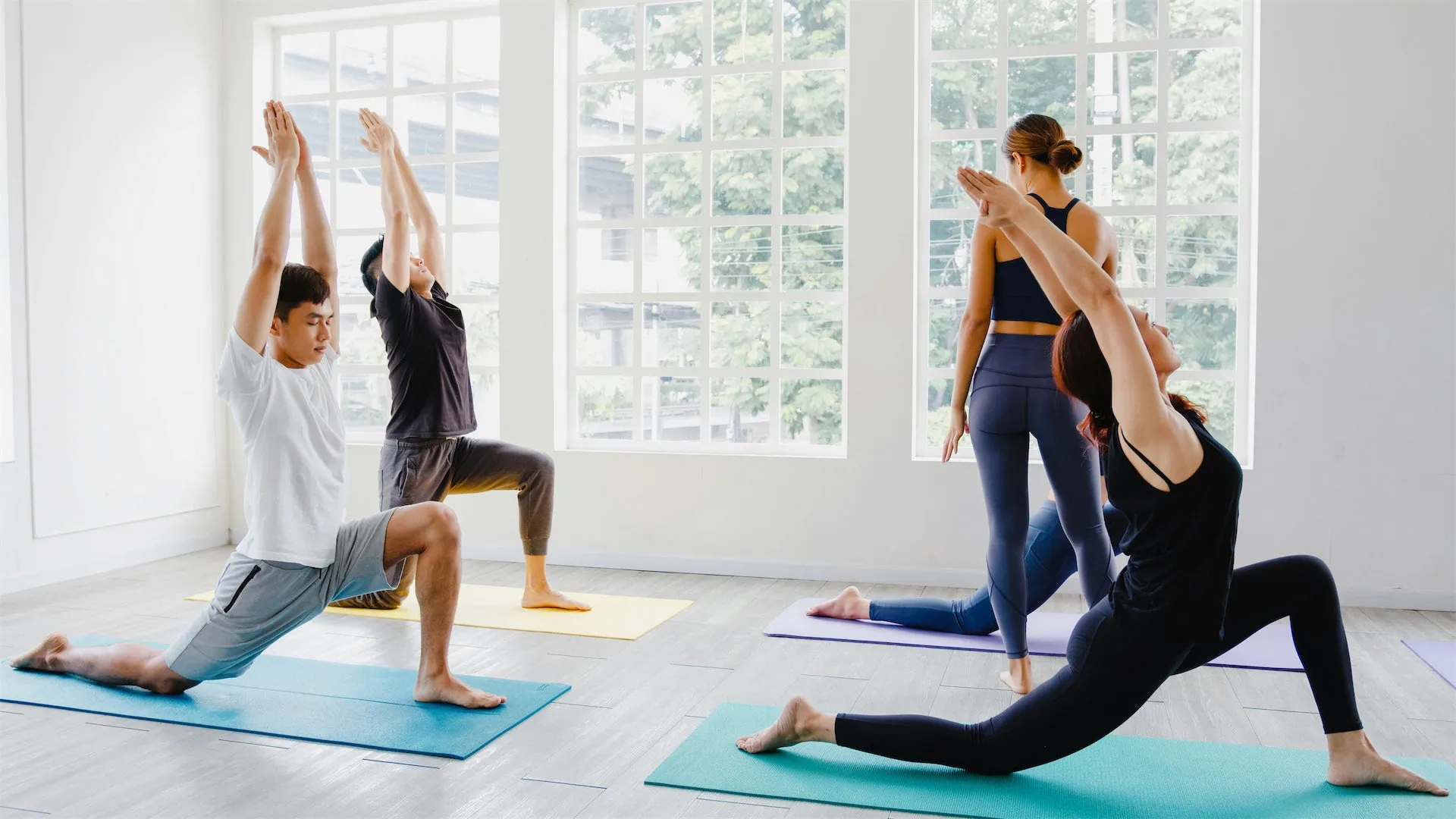 Students on mats in a bright studio
