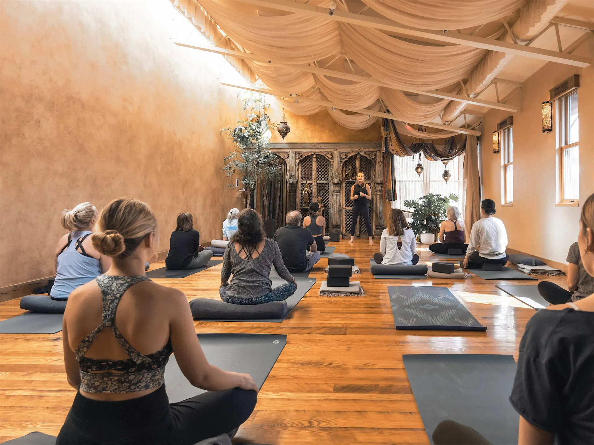 Students practicing yoga in a bright studio